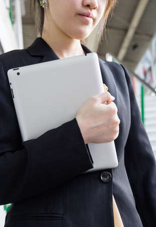 Businesswoman walking down the stairs at skytrain stationの写真素材