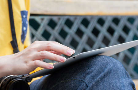 Young woman using digital tablet in the gardenの写真素材
