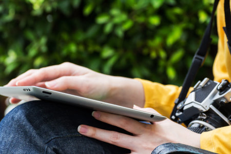 Young woman using digital tablet in the garden