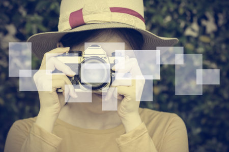 Woman taking photos in the garden. Vintage style.の写真素材