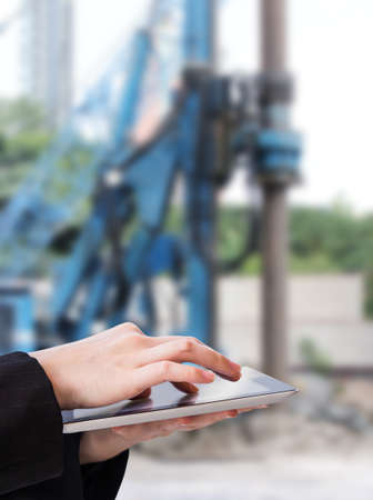 Businesswoman using tablet in construction siteの写真素材
