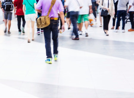 Abstract people are walking in the city. Blurred background.