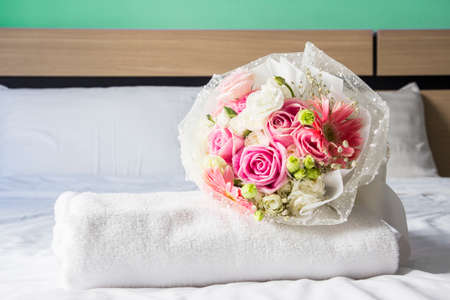 Bouquet on the bed in bedroomの写真素材