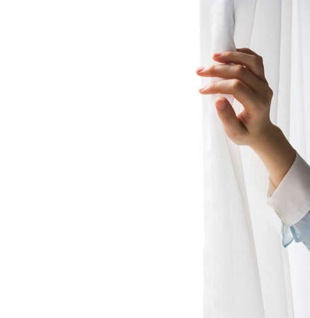 Young woman opening curtainsの写真素材
