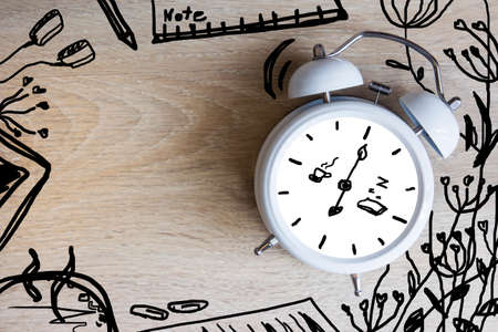 Alarm clock with sketch design on the deskの写真素材