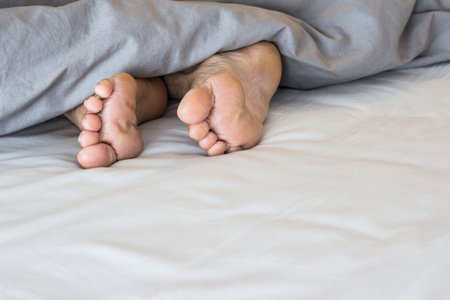 Old feet on the bed