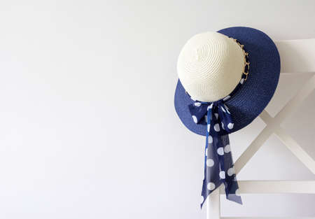 Woman hat hanging on the chairの写真素材
