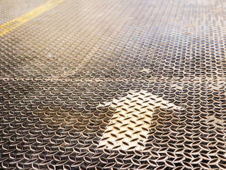 Arrow on grunge metal backgroundの写真素材