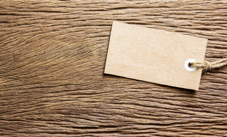 Blank tag tied on wooden background