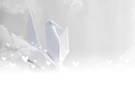 Origami paper crane on skyの写真素材