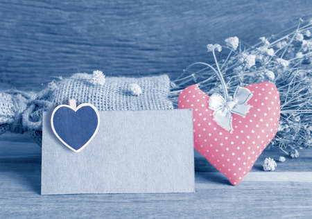 Blank paper tag and dry flowers on wooden backgroundの写真素材