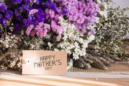 Bouquet of dried flowers with mothers day card on the wooden tableの写真素材