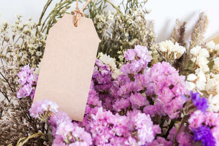 Bouquet of dried flowers with blank paper tagの写真素材