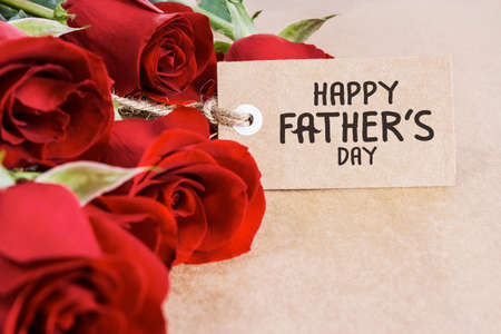 Red roses with fathers day card on brown paperの写真素材