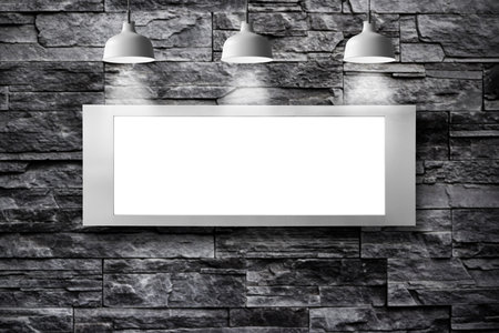 Blank billboard with lamp on stone wall