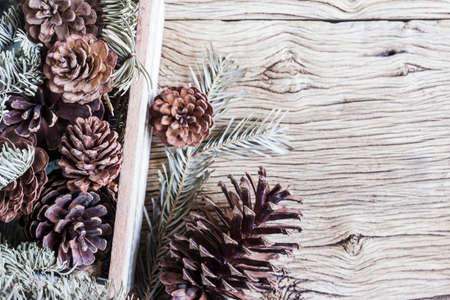 Christmas decoration of pine cones in wooden boxの写真素材