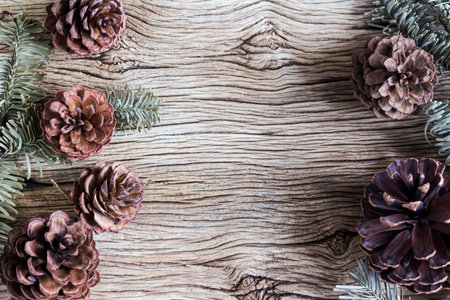 Christmas decoration of pine cones on wooden backgroundの写真素材