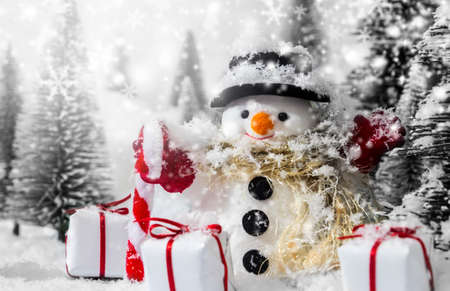 Snowman in the pine forest with snowの写真素材