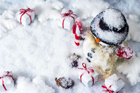Happy snowman and gift box on the snowの写真素材
