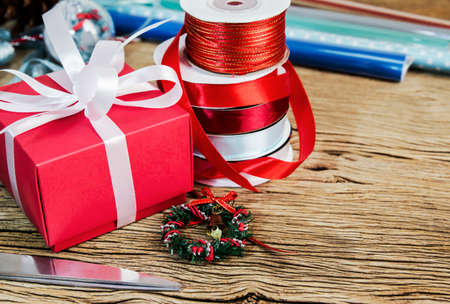 Red gift box and ribbon on the wood tableの写真素材