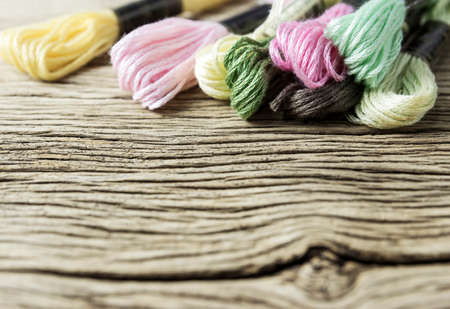 Sewing threads for embroidery on old wood tableの写真素材