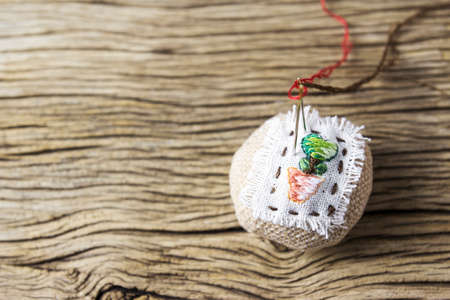 Pin cushion on old wood tableの写真素材