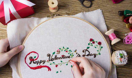 Young woman are embroidered happy valentines dayの写真素材