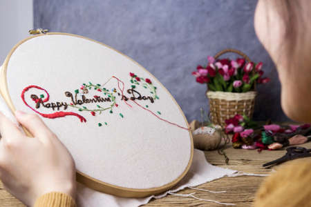 Love concepts of young woman hands are embroidered happy valentines dayの写真素材