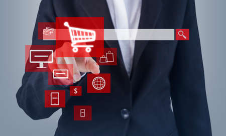 Online shopping concept of business woman hand touching shopping cart iconの写真素材