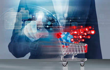 Online shopping concept of shopping cart and business woman hand touching technology designの写真素材