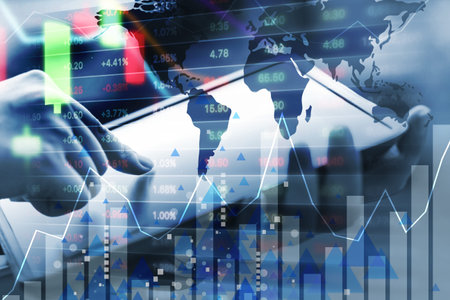 Business concept of young woman are checking stock market by using digital tablet