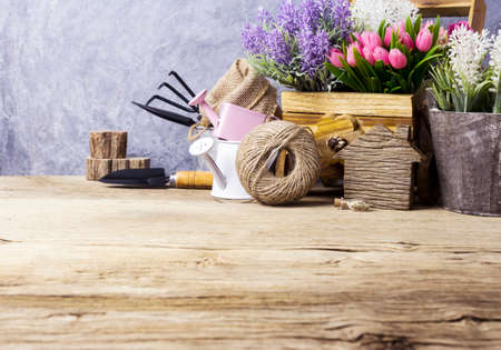 Home and garden concept of gardening tools and flowers on the old woodの写真素材