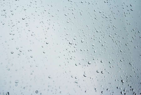 Rain drops on glass window in rainy dayの写真素材