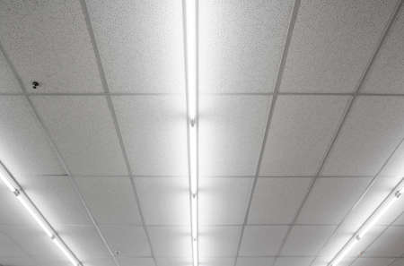 Warm white fluorescent or neon light on ceilingの写真素材