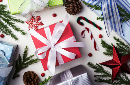 Christmas and New year decoration of gift box and pine leaves and pine cone on paper white...