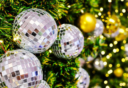 Christmas decoration of disco mirror ball on xmas tree with bokeh lightの写真素材