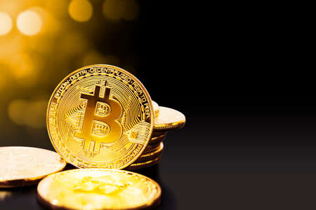 Gold bitcoin on black background with copy spaceの写真素材