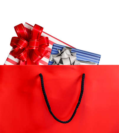Red paper shopping bag and gift box isolated on white background with copy spaceの写真素材