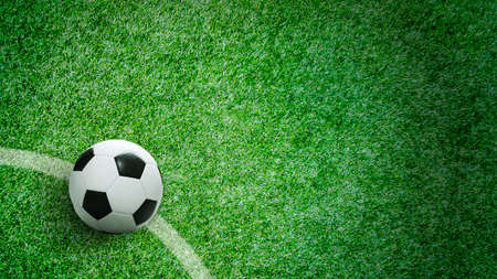 Soccer ball on green grass in stadium with copy spaceの写真素材