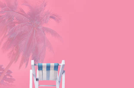 Minimal summer concept of beach chair on pink backgroundの写真素材