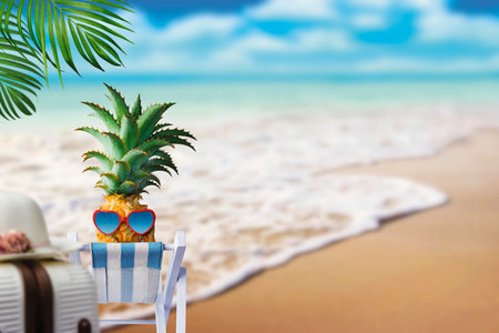 Pineapple on chair at the beach with copy space summer concept