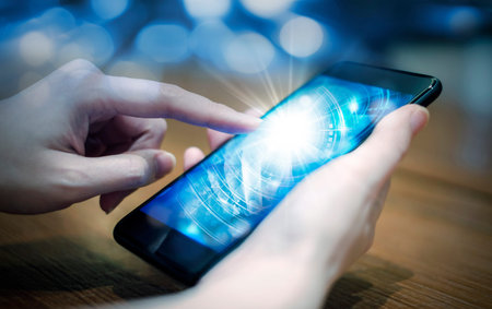 Young woman hand touching digital technology in mobile phone