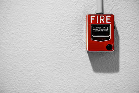 Fire alarm on white wall with copy spaceの写真素材
