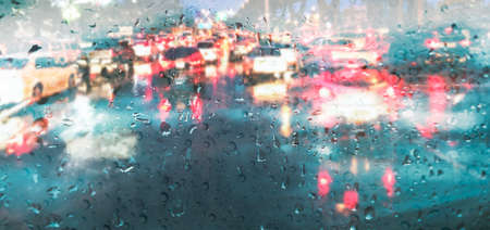 Raindrops on car mirror in rainy season rain backgroundの写真素材