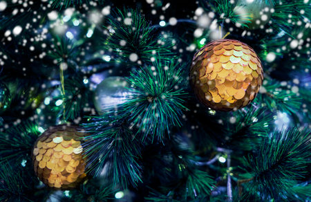 Christmas ball on xmas tree with snow in winter
