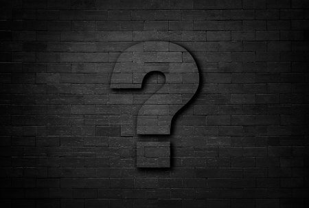 Business concept of question mark on black brick wall texture background