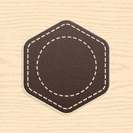 Blank leather badge in retro vintage style. Rounded hexagon shape on wood texture pattern background.のイラスト素材