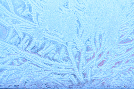 Icy patterns on glass. Winter background with frosty textureの写真素材