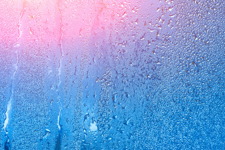 Natural background with condensation on the windows, high humidity. Textures of water droplets of rain flow down the glassの写真素材