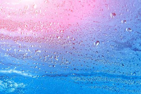 Natural background with condensation on the windows, high humidity. Textures of water droplets of rain flow down the glassの写真素材
